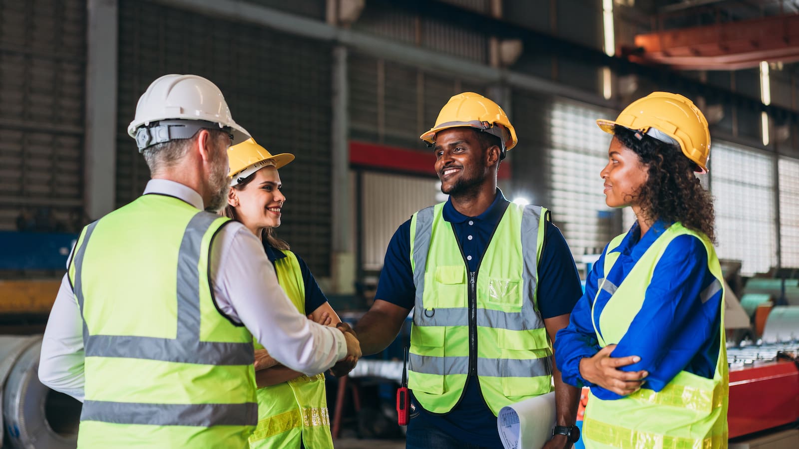 Team engineers and foreman stack hand and shake hands to show success at factory machines. Worker industry join hand for collaboration. Engineers and Foremen on the Jobsite